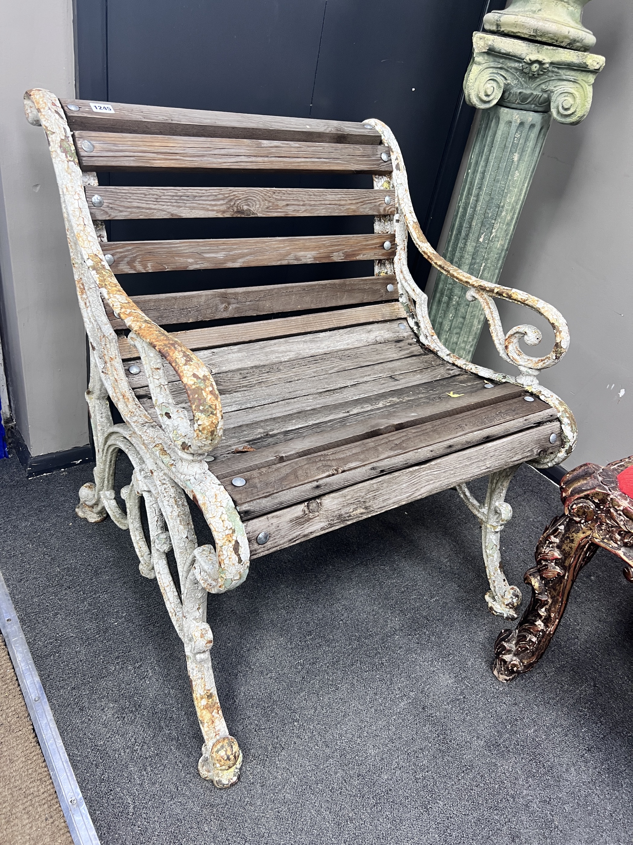 A Victorian painted cast iron slatted garden seat, reduced, width 67cm, depth 64cm, height 76cm